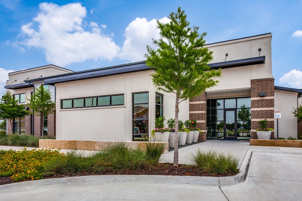 A modern building with a tree in front.