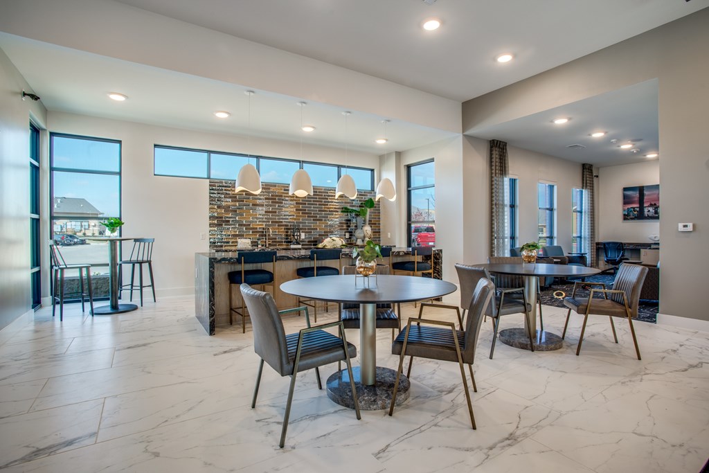 A modern dining room with a large table and chairs.