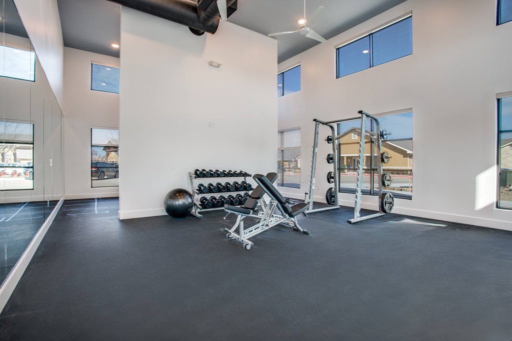 A spacious home gym with a variety of exercise equipment.