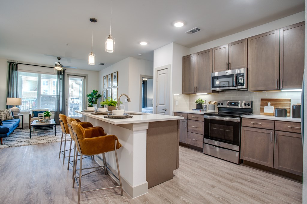 A modern kitchen with a bar area and a dining table.