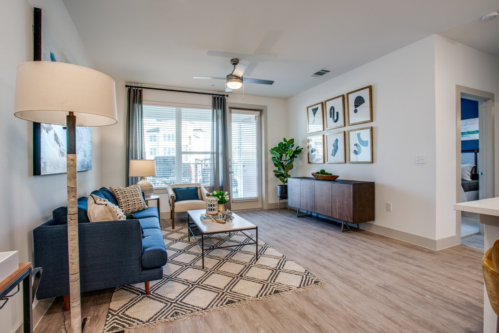 A living room with a blue couch and a coffee table.