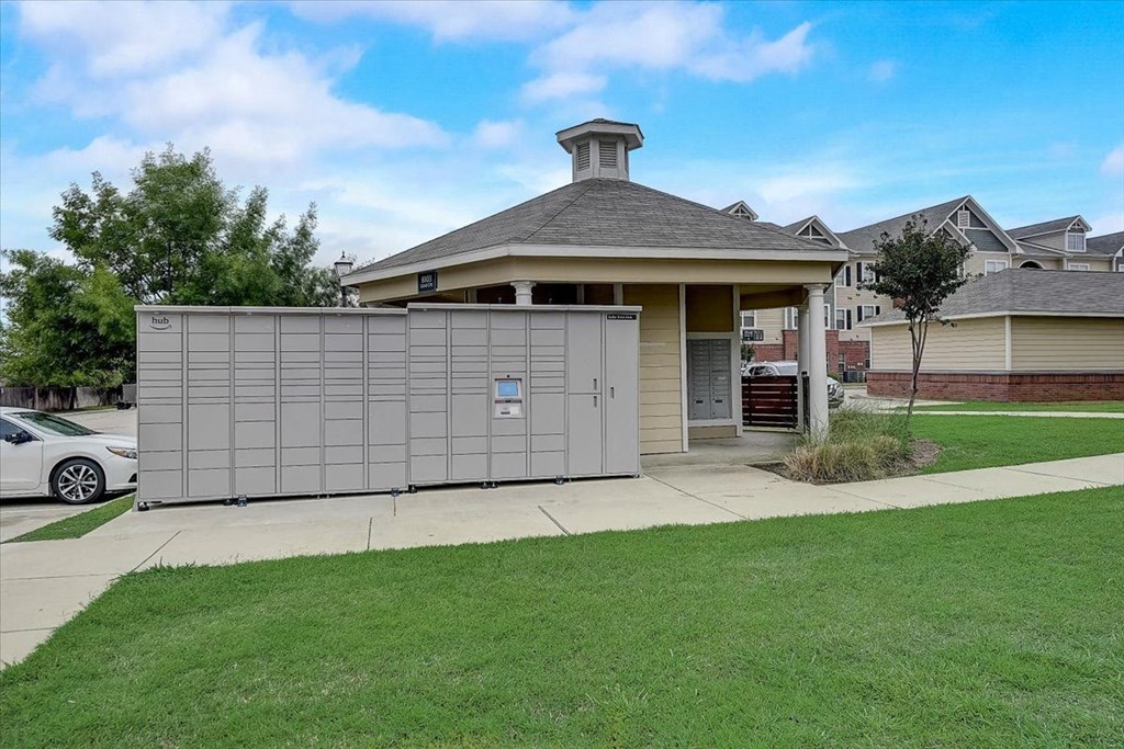 a garage with a fence in front of a house
