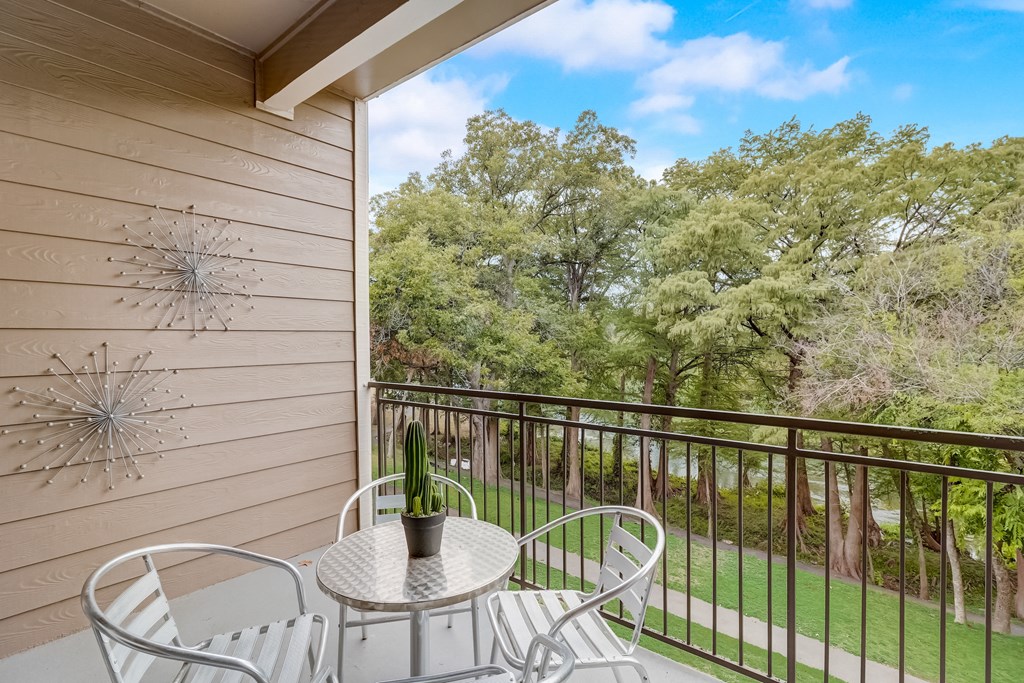 a patio with a table and chairs on a balcony