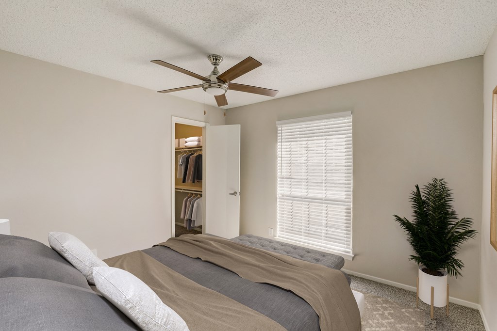 a bedroom with a bed and a ceiling fan