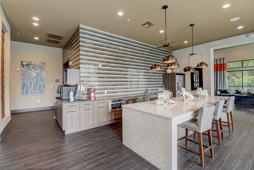 a kitchen with a large island and a table with chairs