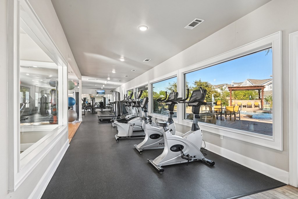 A gym with treadmills and exercise bikes.