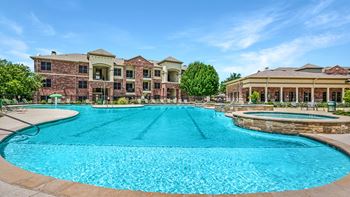 A large swimming pool in front of a building.