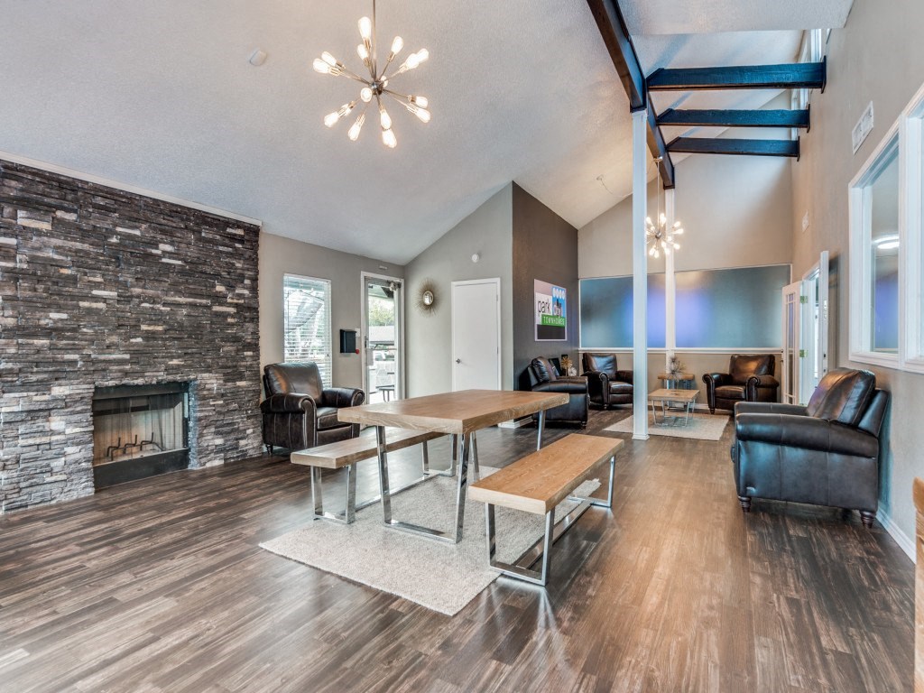 a living room with a fireplace and a table and chairs