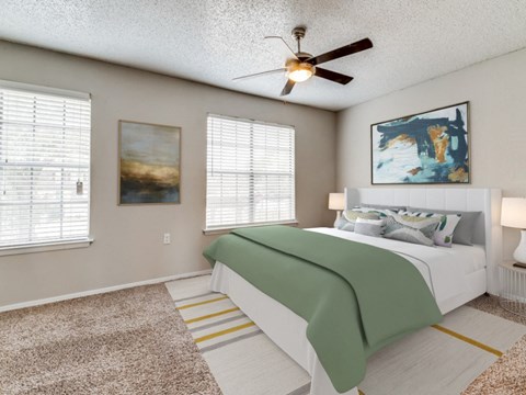a bedroom with a bed and a ceiling fan
