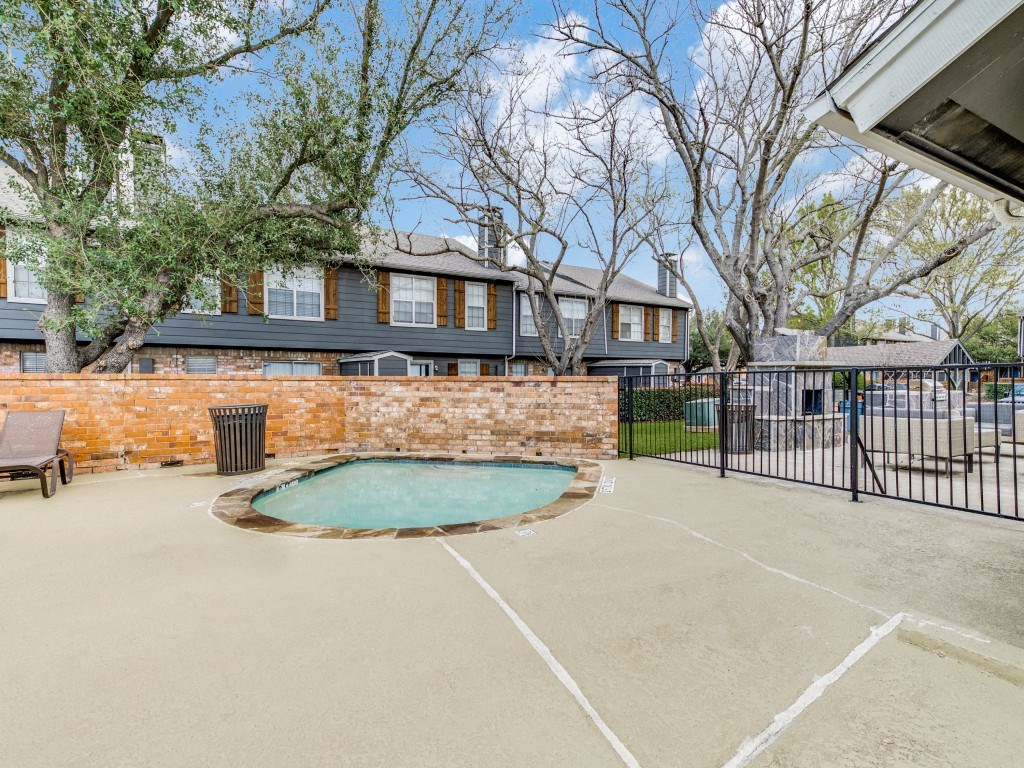a basketball court with a pool in front of a house