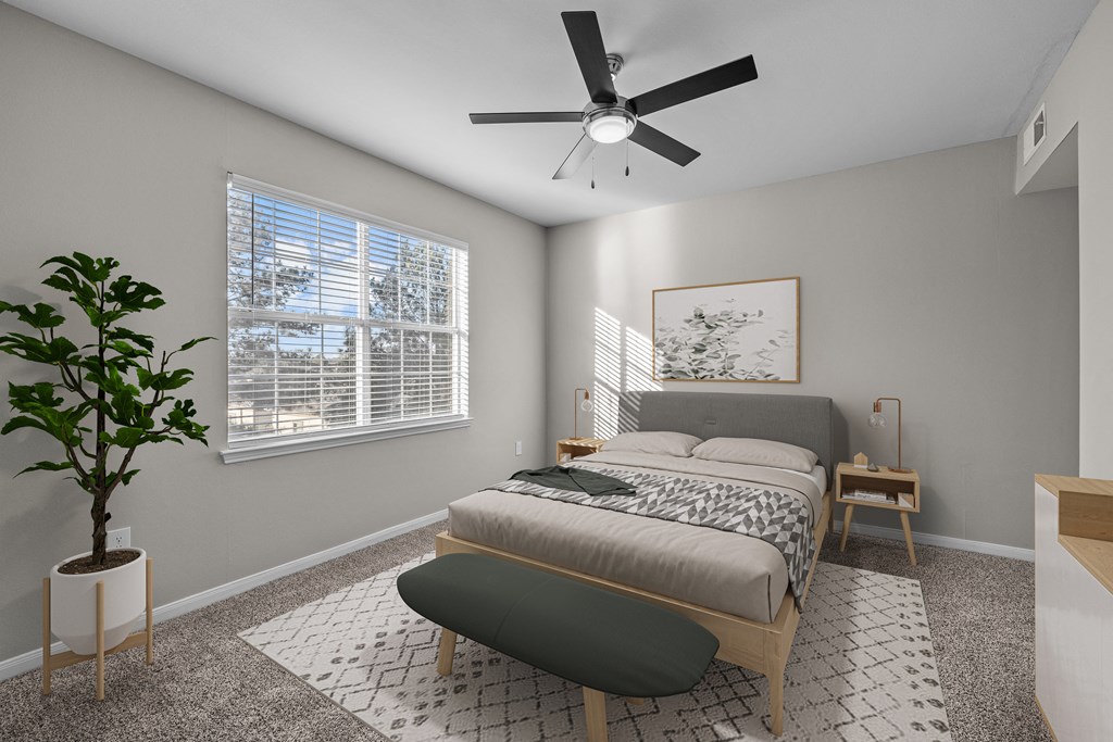 a bedroom with a bed and a ceiling fan