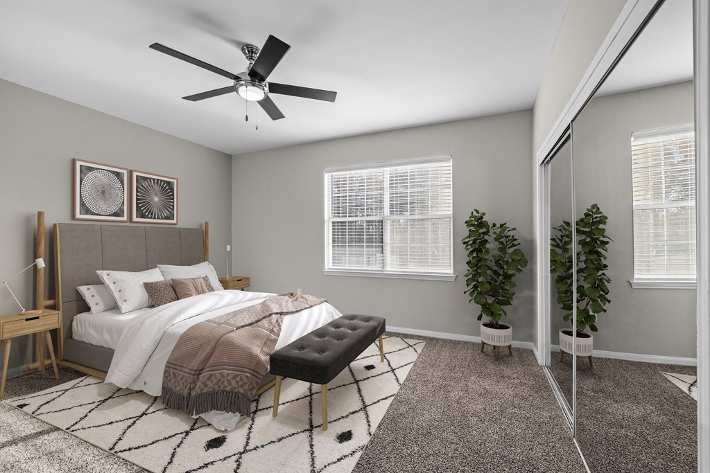 an open bedroom with a large bed and a ceiling fan