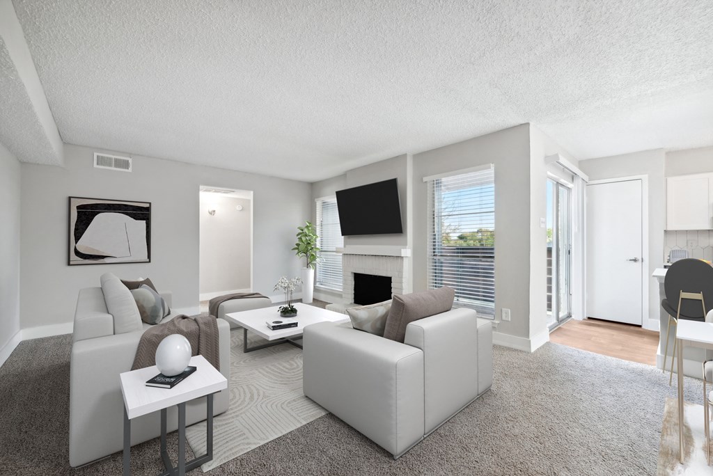 a living room with white furniture and a fireplace