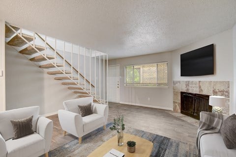 a living room with a staircase and a tv