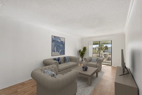 A living room with a couch, a coffee table, and a painting on the wall.