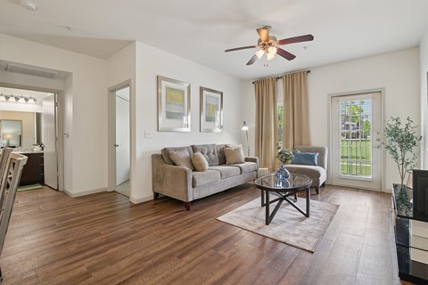 A living room with a brown sofa and a coffee table.