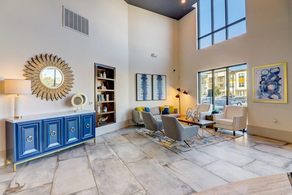 a living room with couches and chairs and a table and a mirror