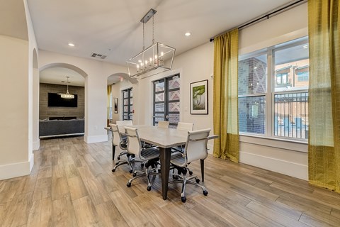 A conference room with a long table and chairs.