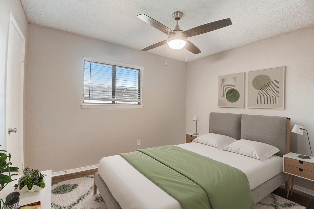 a bedroom with a bed and a ceiling fan