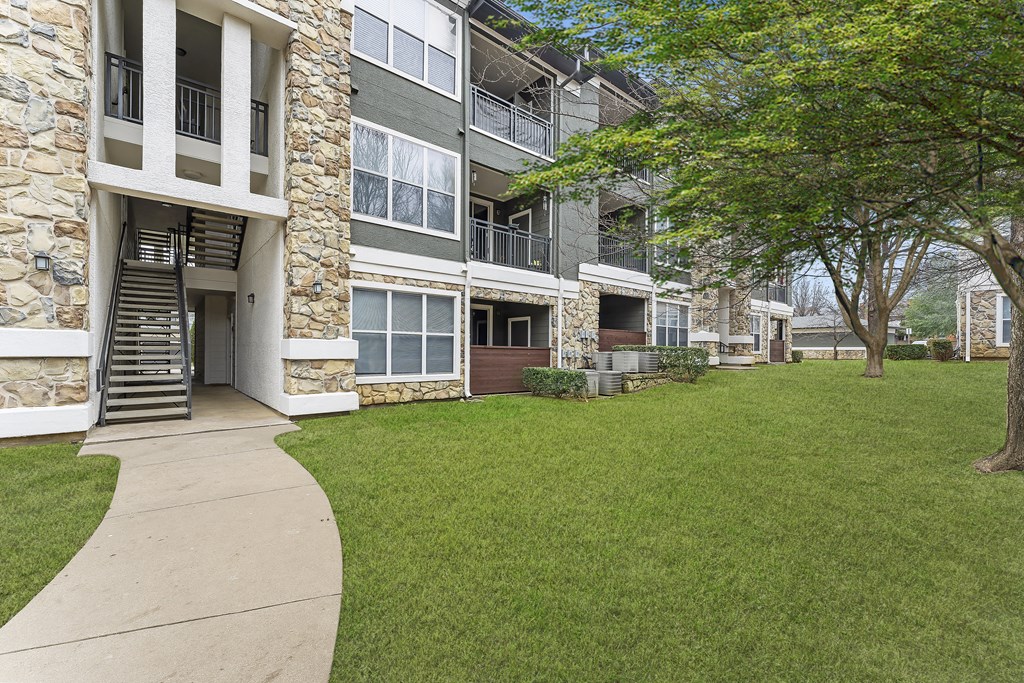 our apartments have a spacious courtyard with green grass and trees