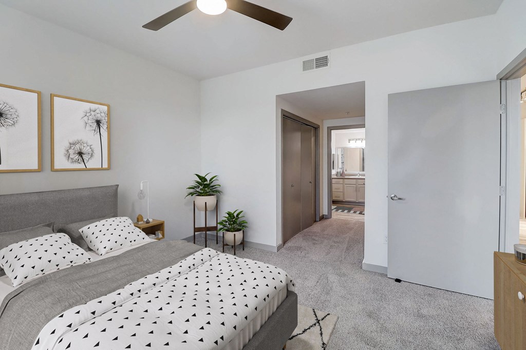 a bedroom with a bed and a ceiling fan