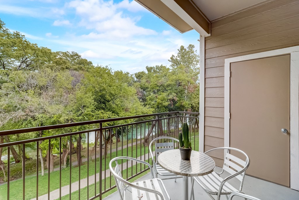 a patio with a table and chairs on a balcony