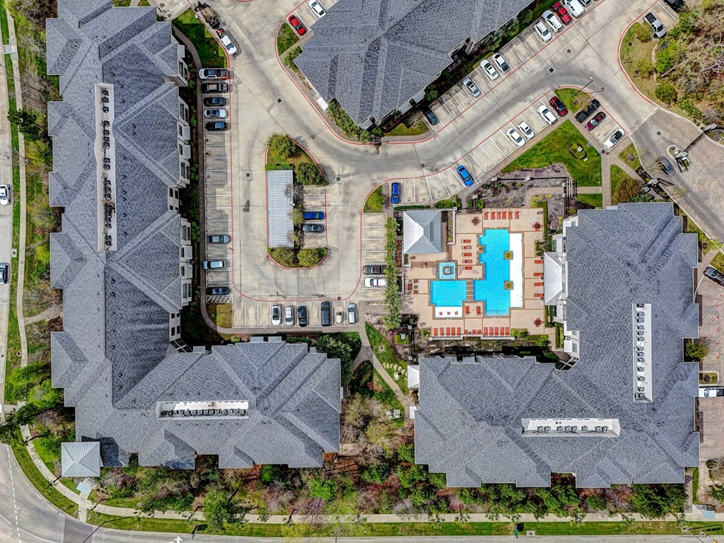 a birds eye view of a neighborhood with houses and a parking lot