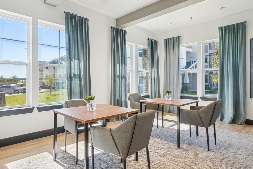 A dining room with a table and chairs.