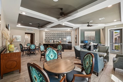 A modern dining room with a glass backsplash and patterned chairs.