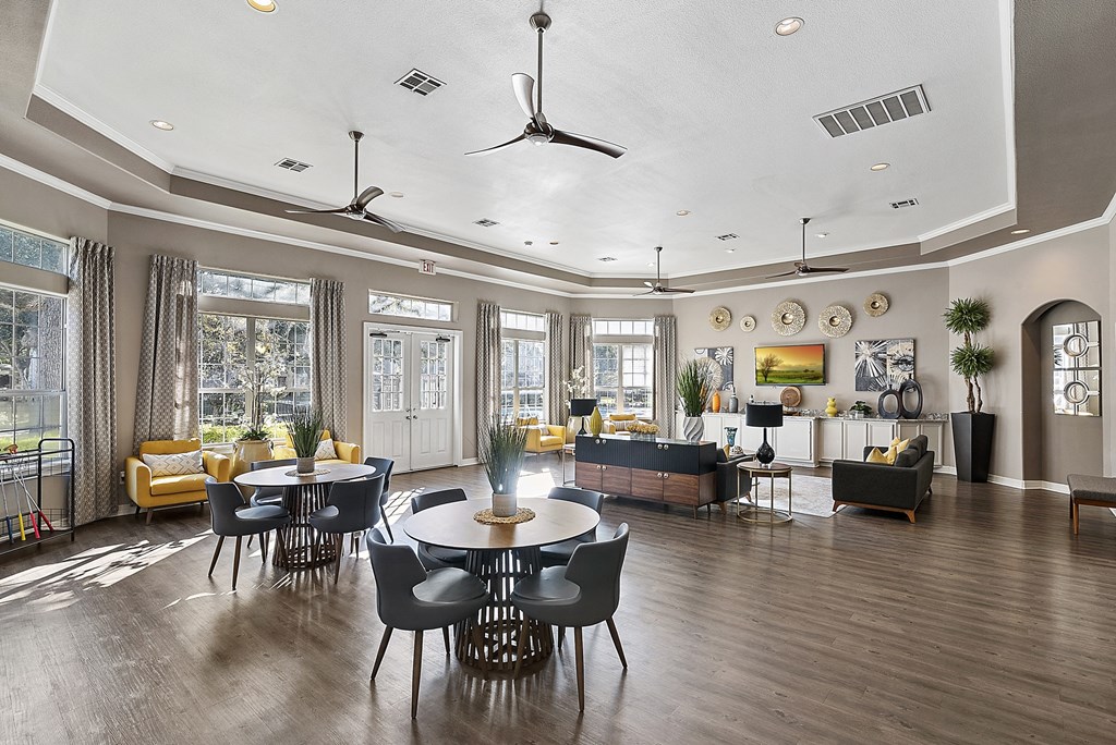 a large living room with a table and chairs and a couch