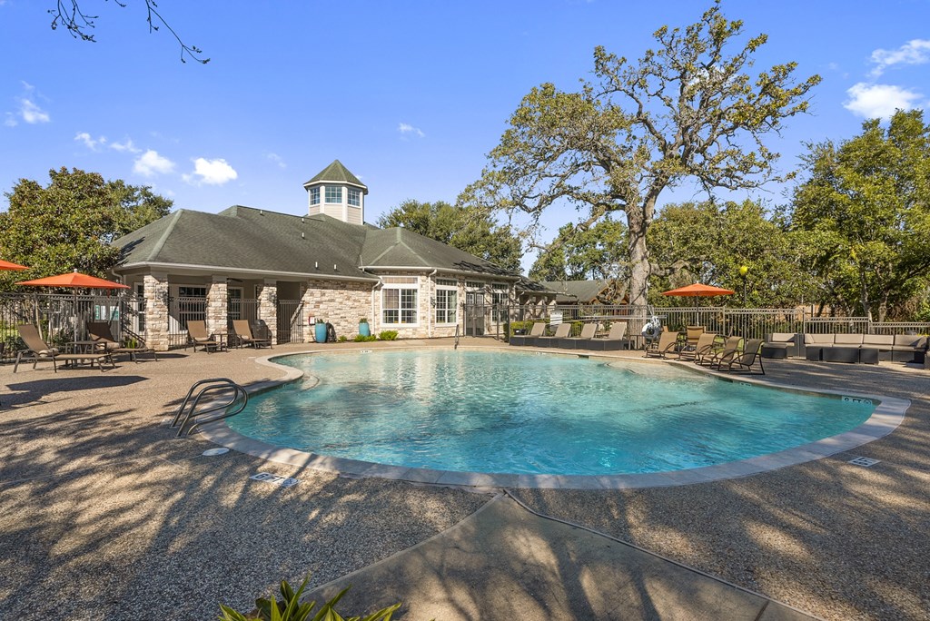 a resort style pool with a building in the background