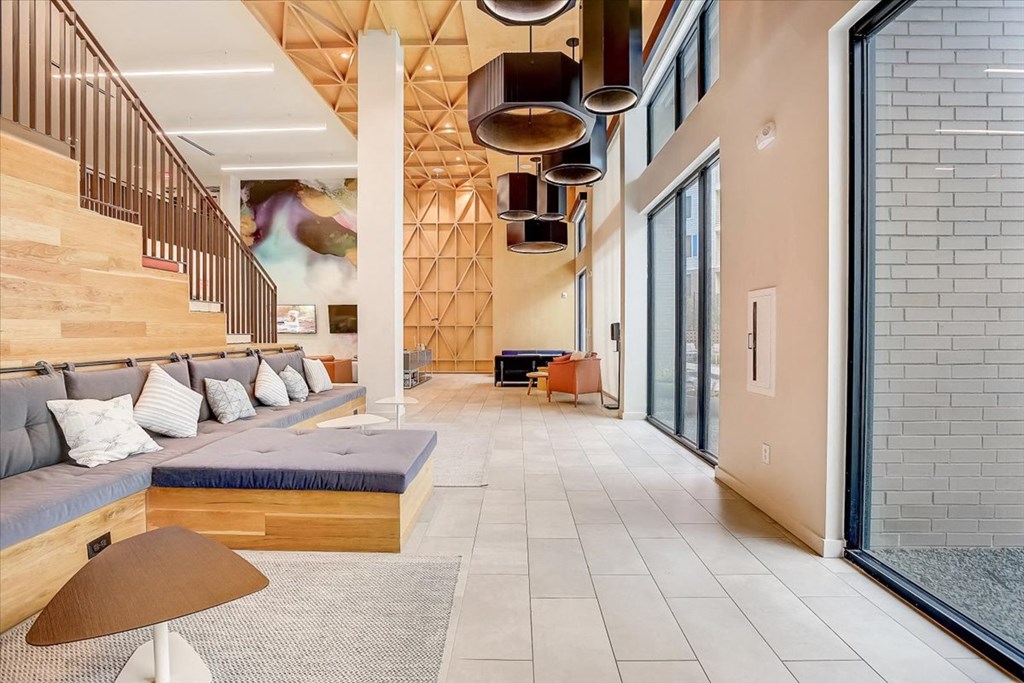 a large living room with a couch and a staircase