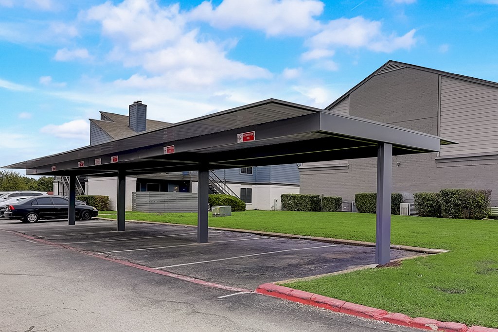 a covered parking lot in front of a building