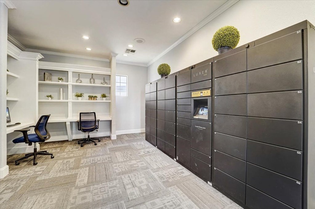 the lockers in the center of a room with a desk and chair