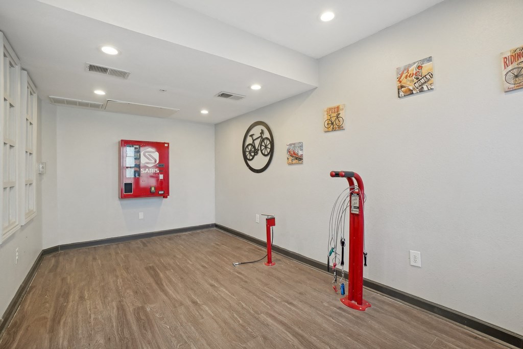A room with a red piece of equipment and a clock on the wall.