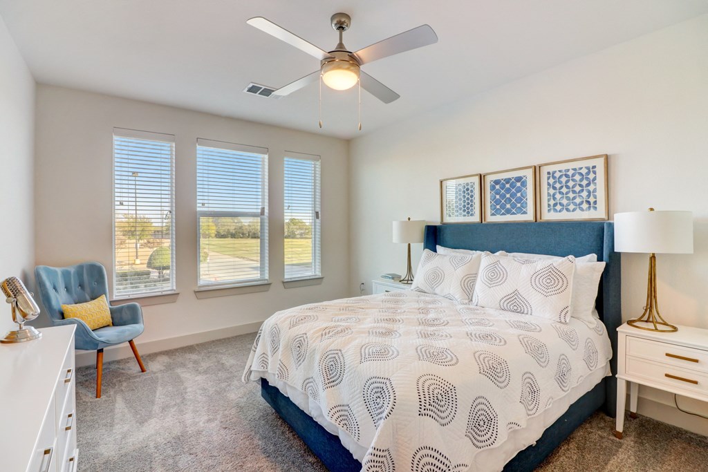 a bedroom with a bed and a ceiling fan