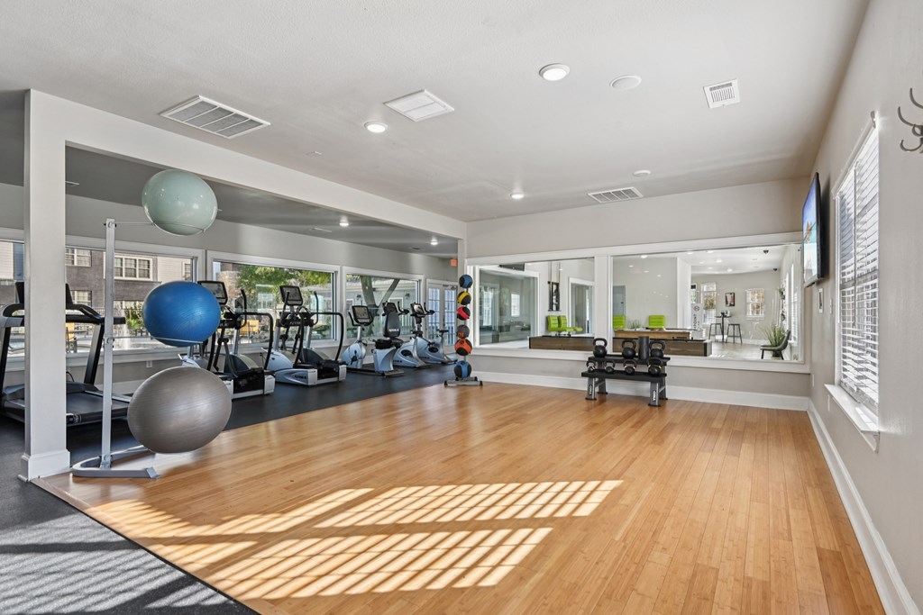 A gym with a variety of exercise equipment.
