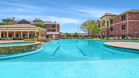 A large swimming pool in front of a building.
