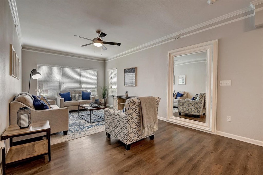 a living room with couches and chairs