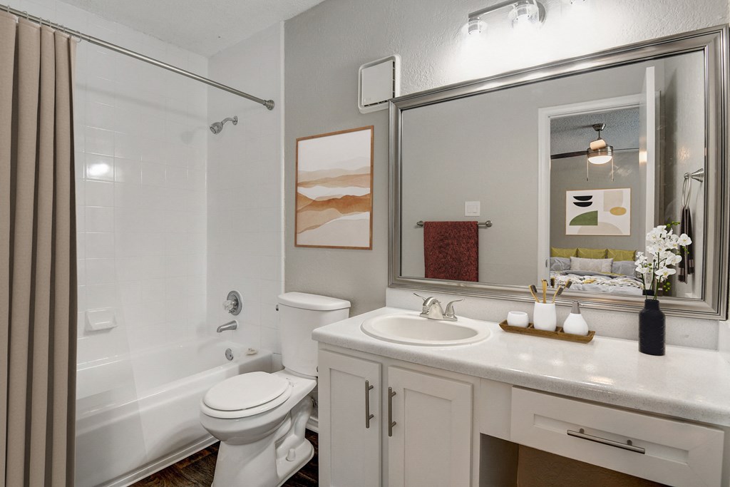 a bathroom with a white sink and toilet next to a white bathtub