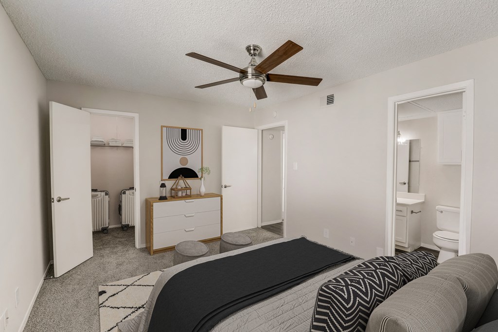 a bedroom with a bed and a ceiling fan