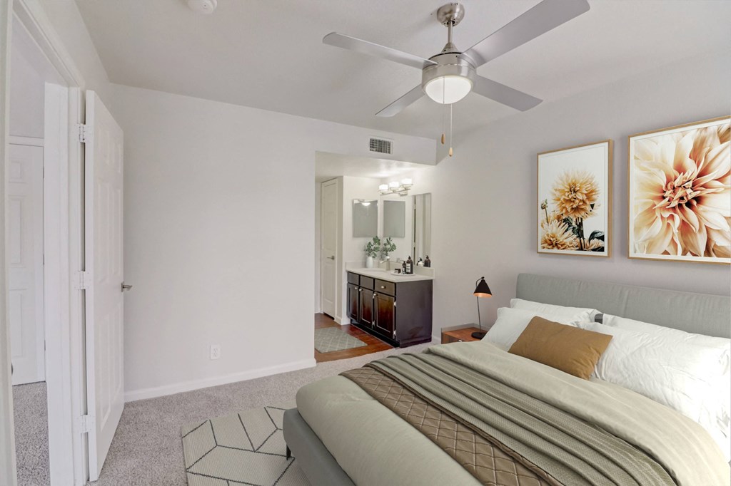 a bedroom with a large bed and a ceiling fan
