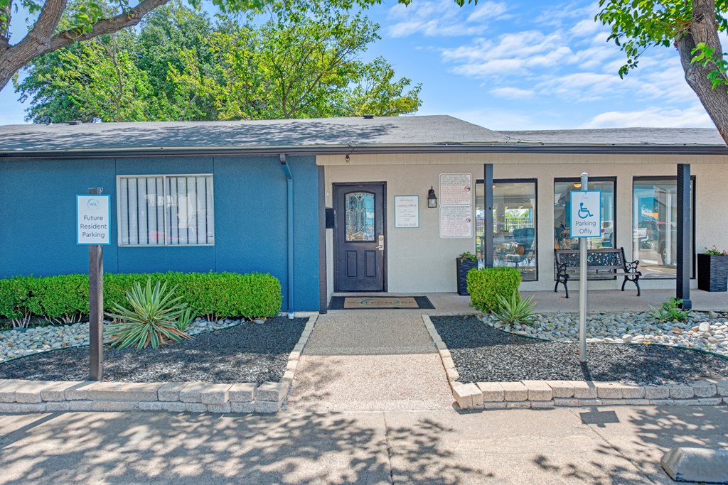 a blue building with a blue door and a sidewalk in front of it