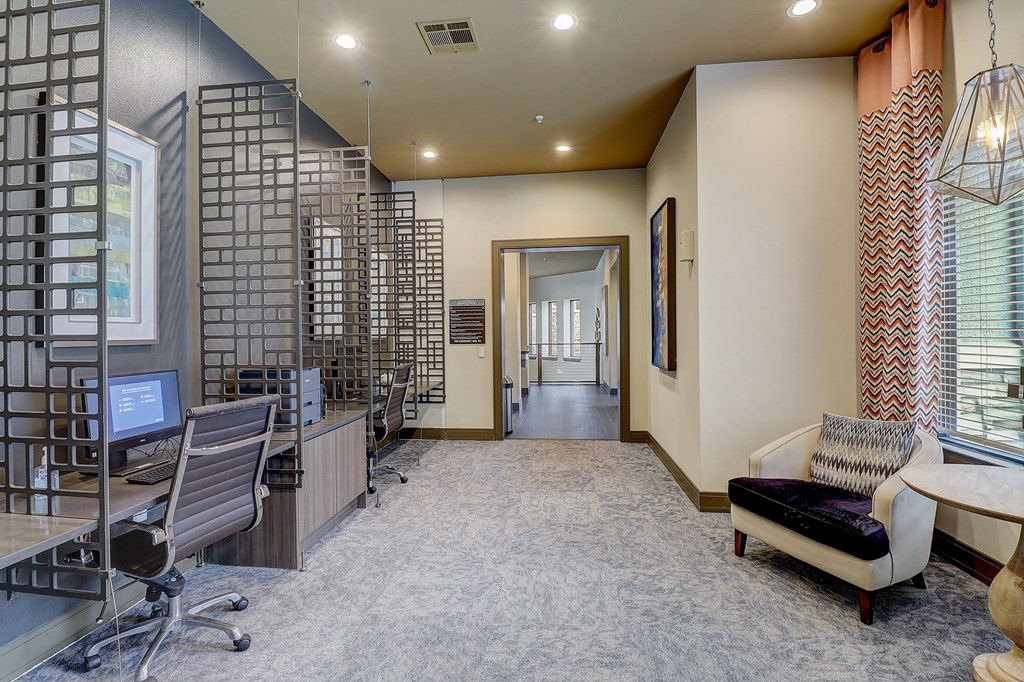 a large office with a desk and chairs and a computer