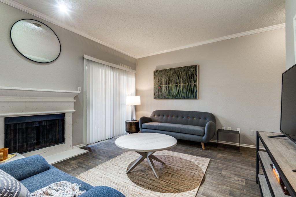 a living room with a couch and a coffee table and a fireplace