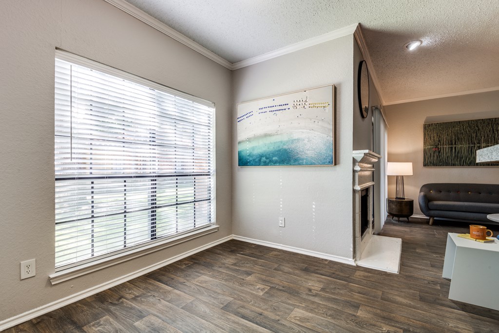 a living room with a large window and a couch and a table
