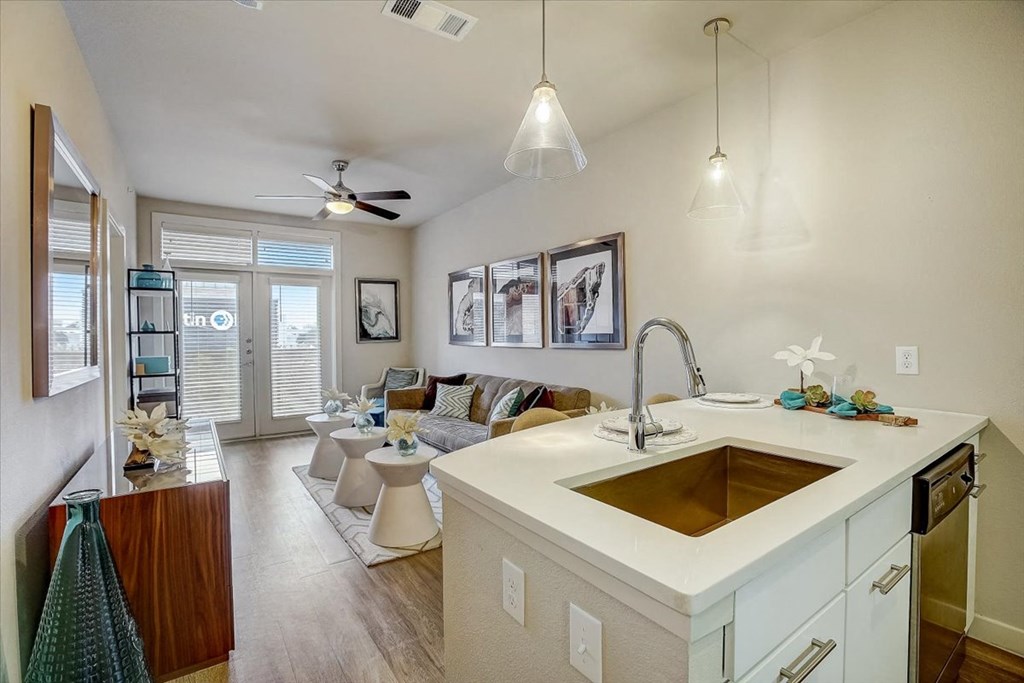 a kitchen with a sink next to a living room