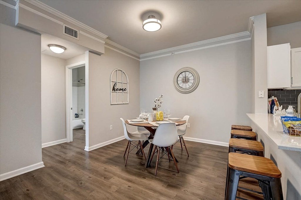 a dining room with a table and chairs