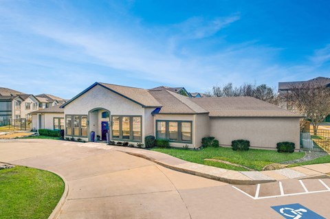 a house with a driveway and a street sign in front of it