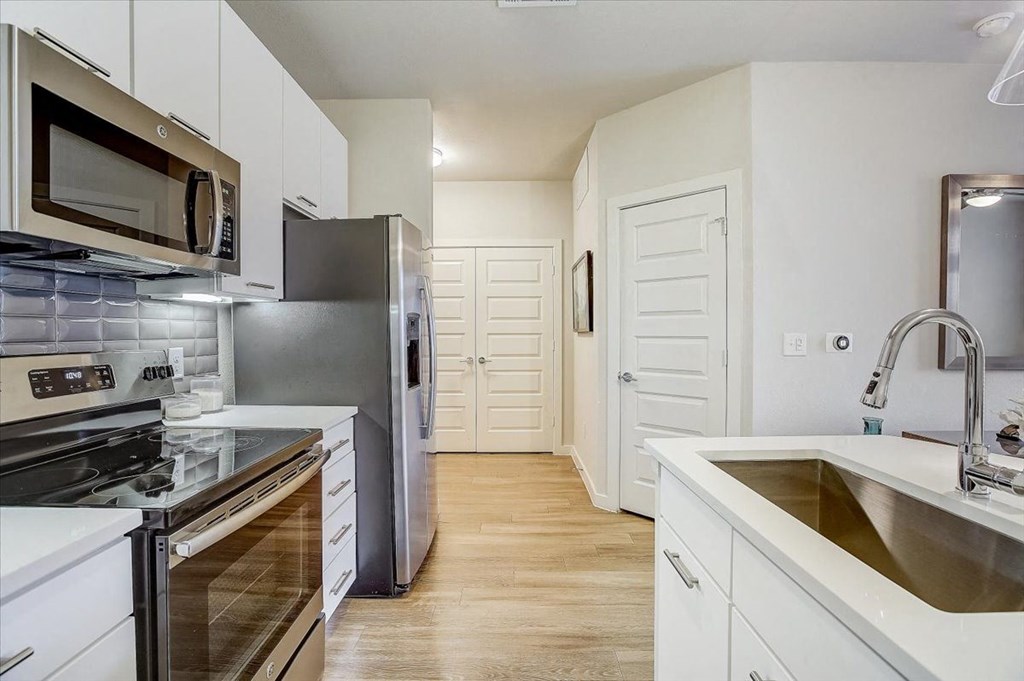 a kitchen with stainless steel appliances and a sink